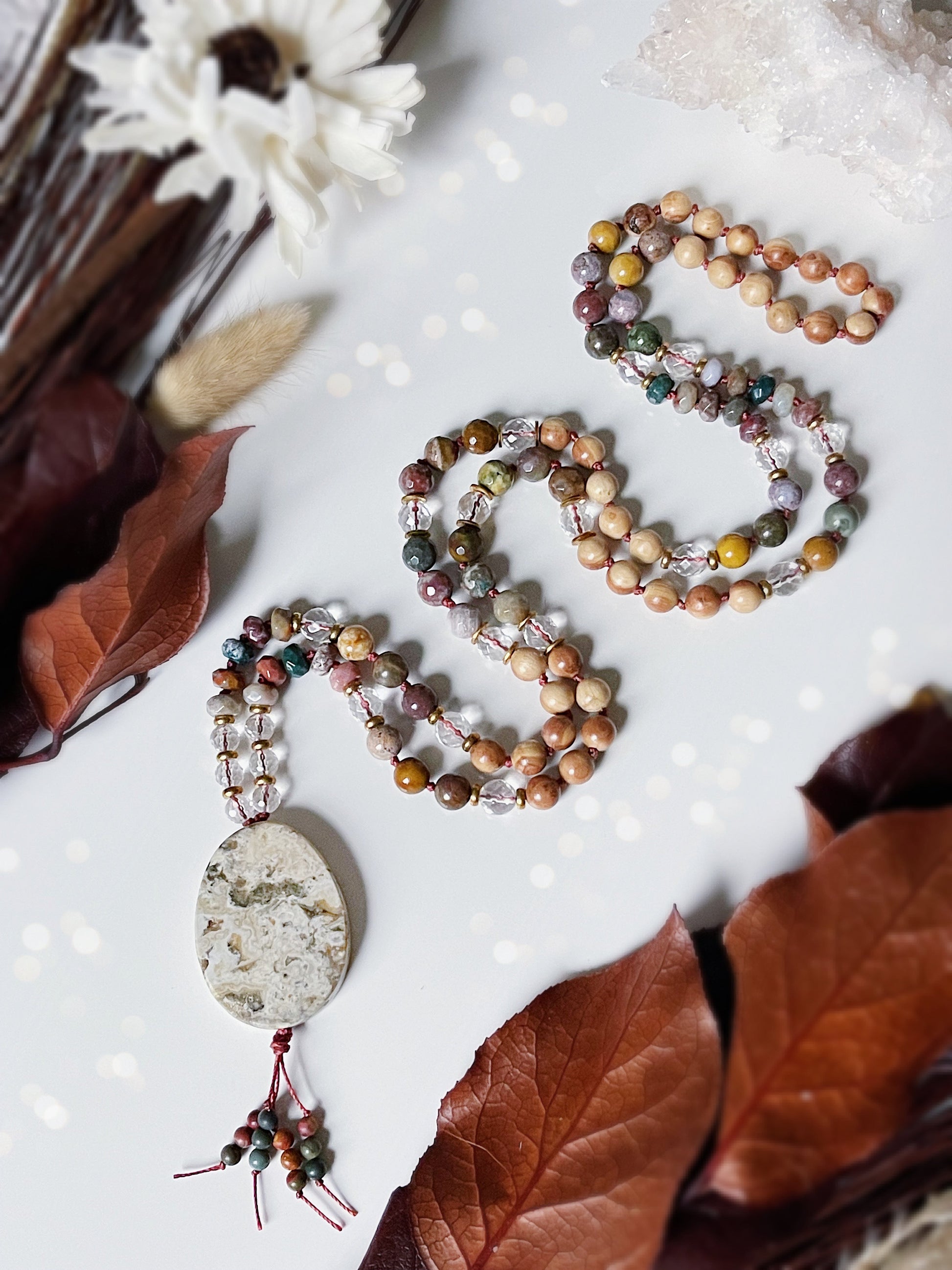 Grounded Within Mala. 108 beads of Ocean Jasper, Clear Quartz and Pearwood with brass spacers and an Ocean Jasper pendant. Available at The Crystalline Moon. 